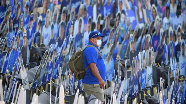 Jul 26, 2020; Los Angeles, California, USA; A grounds crew member makes his way through a maze of fan cut outs before the game between the Los Angeles Dodgers and the San Francisco Giants at Dodger Stadium. Mandatory Credit: Jayne Kamin-Oncea-USA TODAY Sports